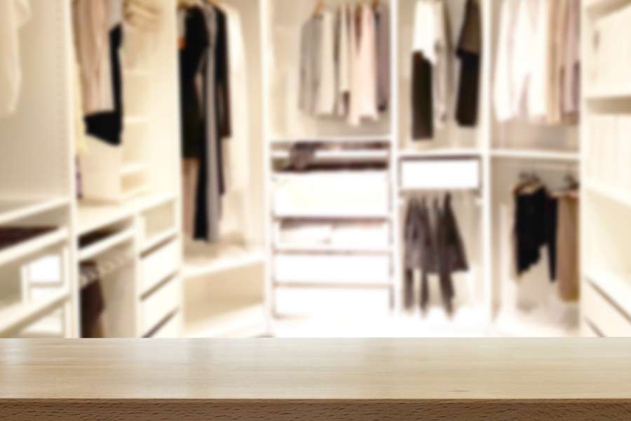Un comptoir en bois brut met en valeur un élégant dressing sur mesure en arrière-plan.